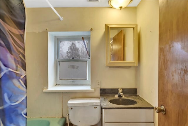 bathroom featuring vanity and toilet