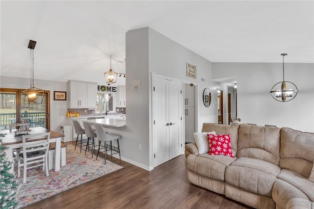 living room with hardwood / wood-style floors and high vaulted ceiling