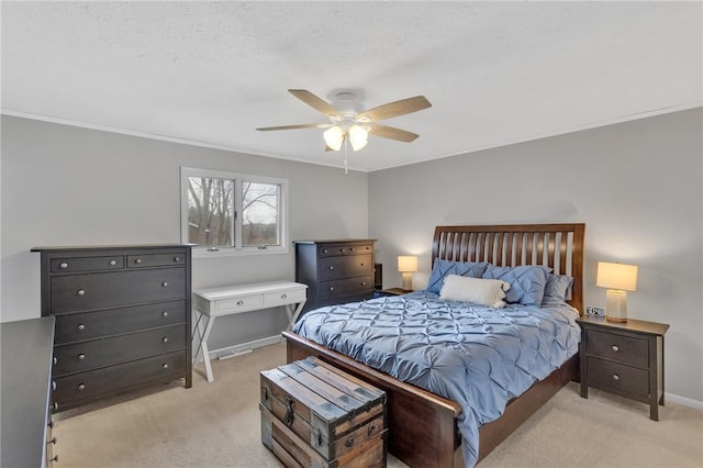 carpeted bedroom with a textured ceiling, ceiling fan, and crown molding