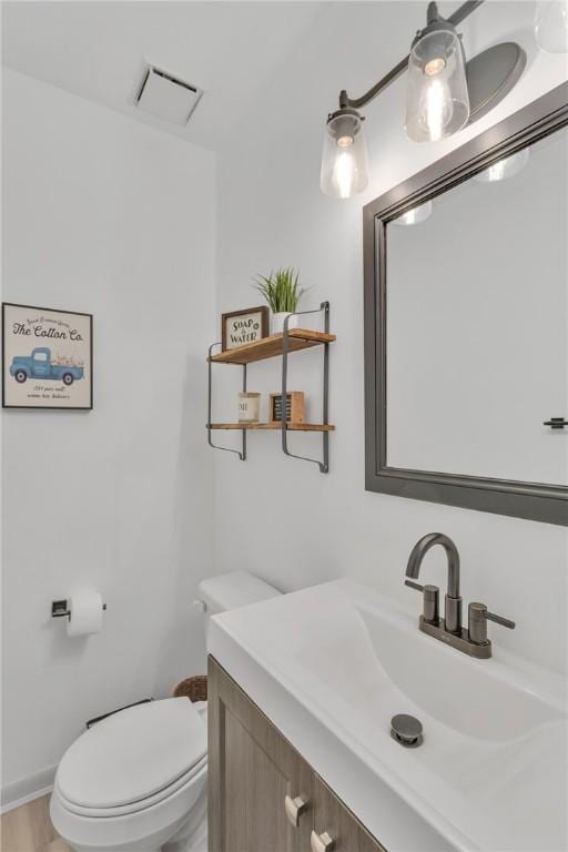 bathroom with vanity and toilet