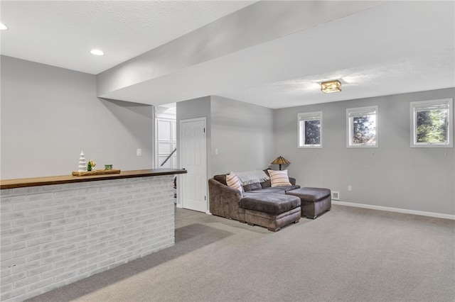 living area featuring light colored carpet and indoor bar