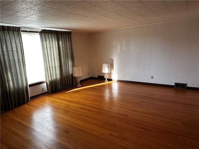 spare room with wood-type flooring