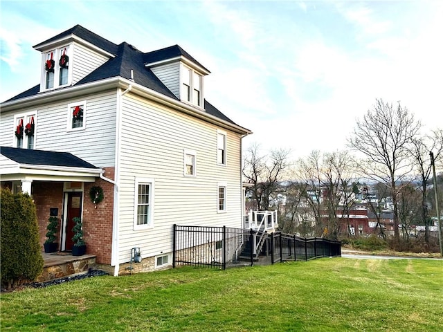 view of side of home with a lawn