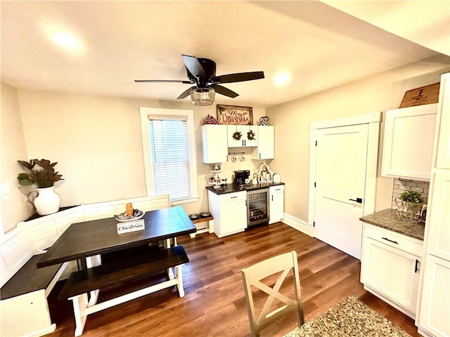 dining room with dark hardwood / wood-style floors, ceiling fan, and wine cooler