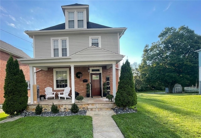 front of property featuring a front yard and covered porch