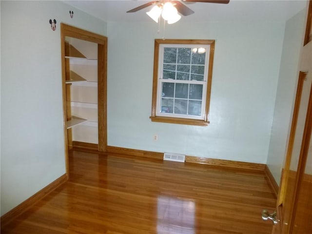 empty room featuring hardwood / wood-style flooring and ceiling fan