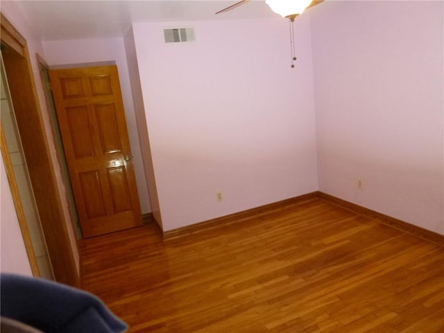 unfurnished room featuring hardwood / wood-style floors and ceiling fan