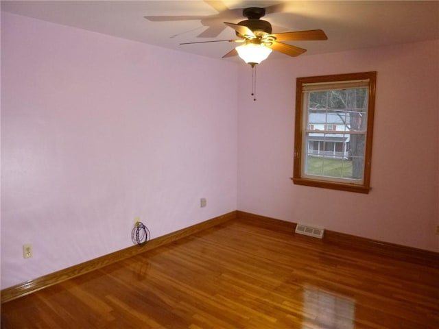 unfurnished room with ceiling fan and wood-type flooring