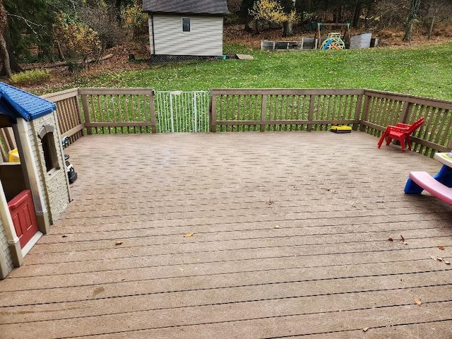 wooden terrace featuring a lawn