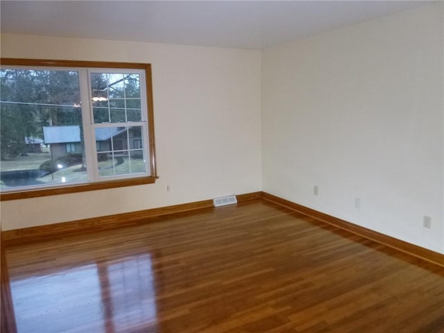 empty room featuring wood-type flooring