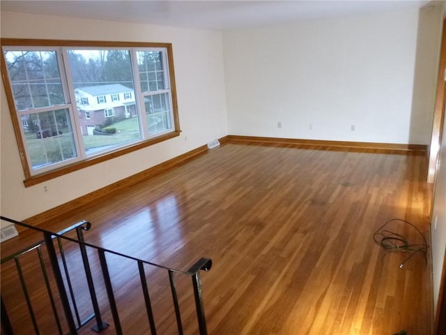 spare room featuring hardwood / wood-style flooring