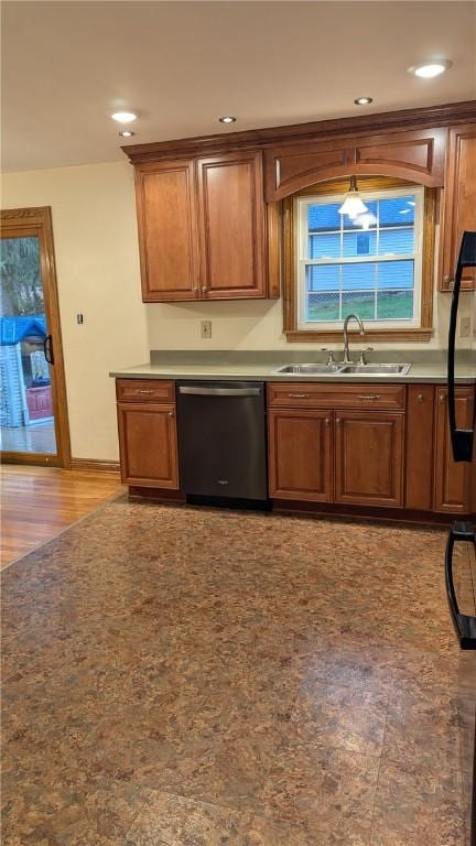 kitchen with dishwasher, light hardwood / wood-style flooring, and sink