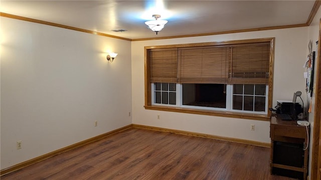 empty room with crown molding and dark wood-type flooring