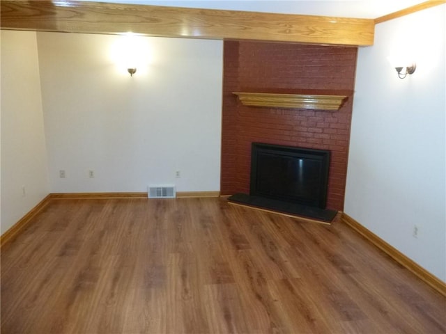 unfurnished living room with a fireplace and hardwood / wood-style flooring