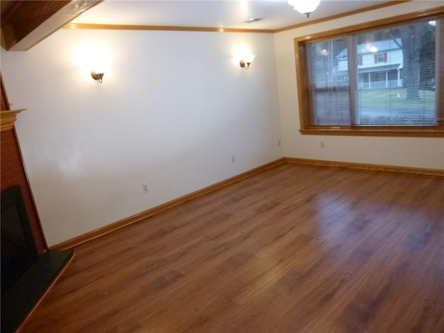 interior space featuring beam ceiling, hardwood / wood-style flooring, and crown molding