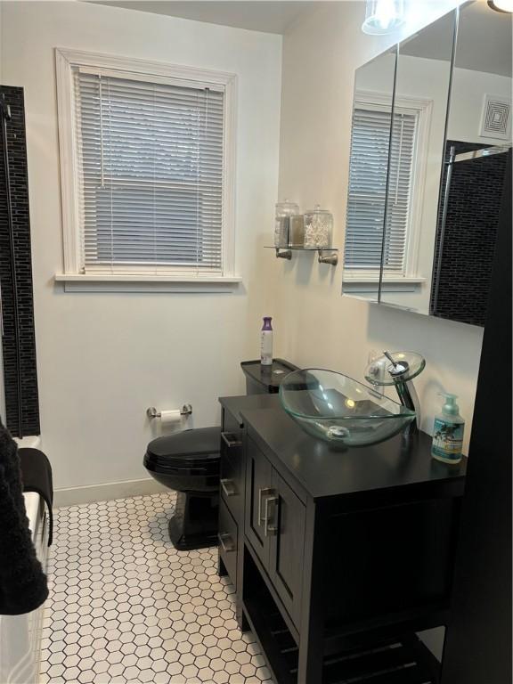 bathroom featuring vanity and toilet