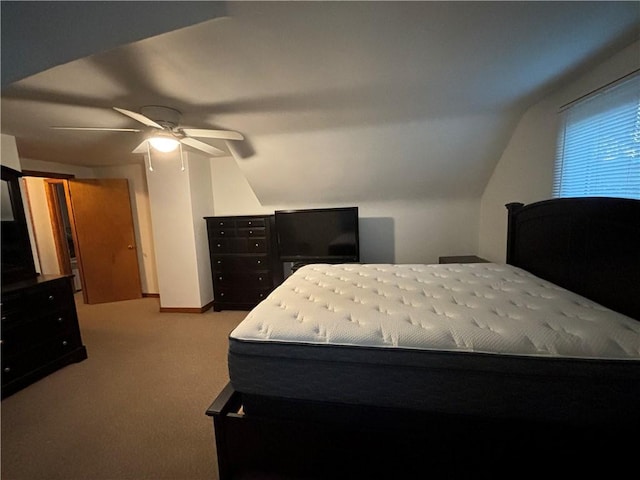 bedroom featuring ceiling fan, light colored carpet, and vaulted ceiling