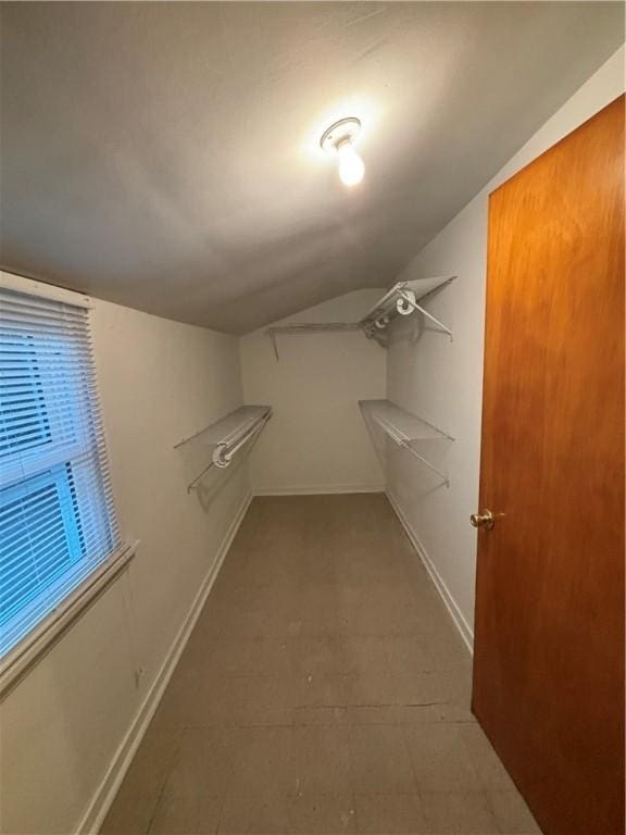 walk in closet featuring lofted ceiling