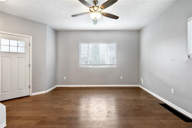 entryway with plenty of natural light, dark hardwood / wood-style floors, a textured ceiling, and ceiling fan