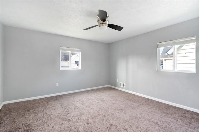 empty room featuring carpet and ceiling fan