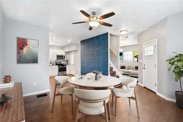 dining room with dark hardwood / wood-style flooring and ceiling fan