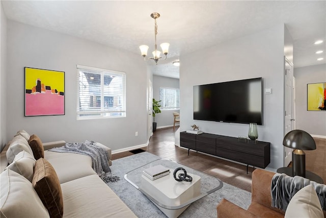 living room with dark hardwood / wood-style flooring and a notable chandelier