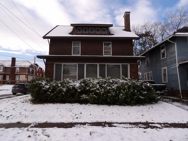 view of snow covered rear of property