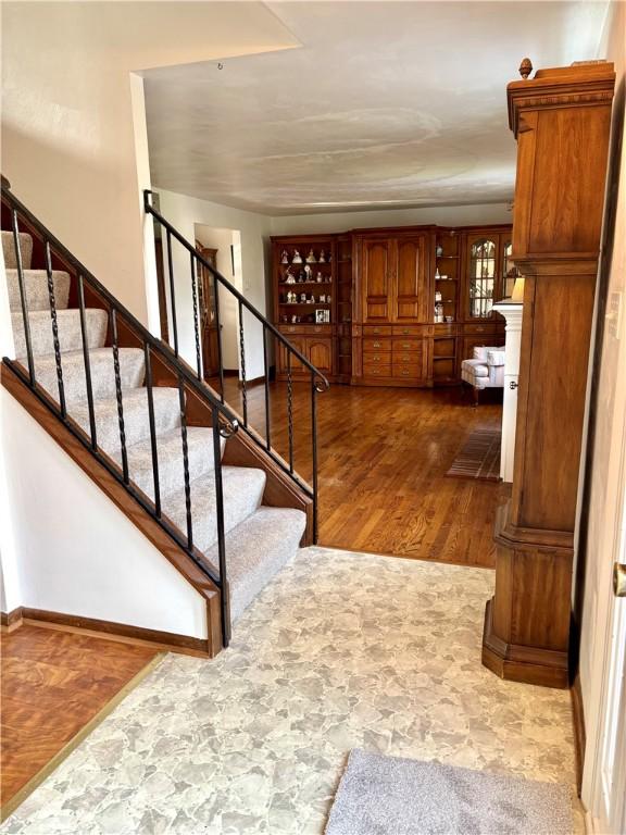 staircase with hardwood / wood-style flooring