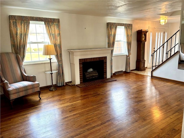 unfurnished living room with a fireplace and wood-type flooring