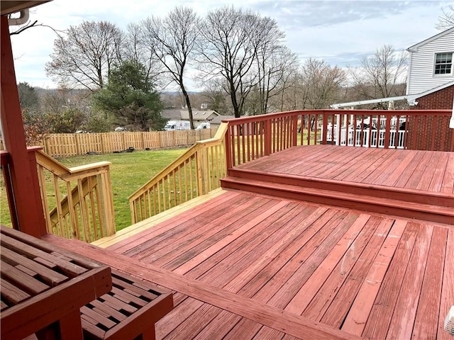 wooden terrace featuring a yard