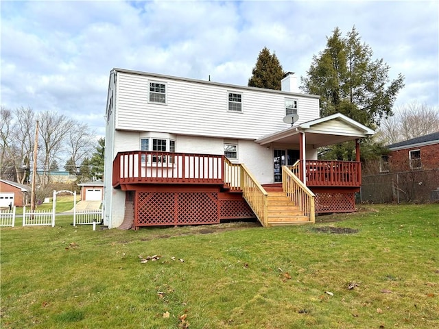 back of house featuring a wooden deck and a yard