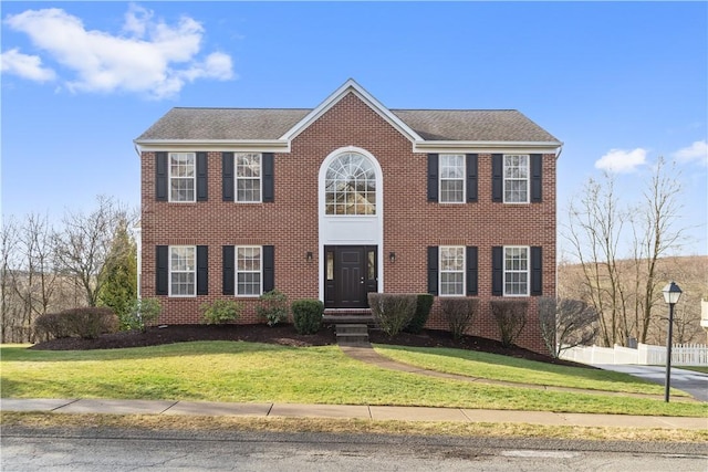 colonial-style house with a front yard