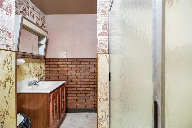 bathroom featuring tile patterned flooring, vanity, and tile walls