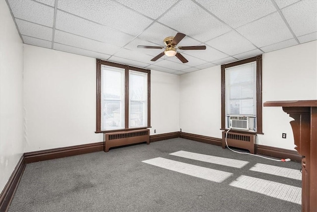 empty room with radiator, carpet floors, and a healthy amount of sunlight