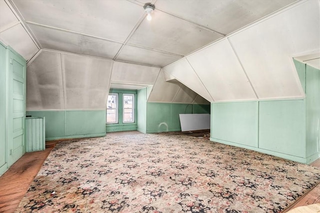 bonus room with lofted ceiling and light wood-type flooring