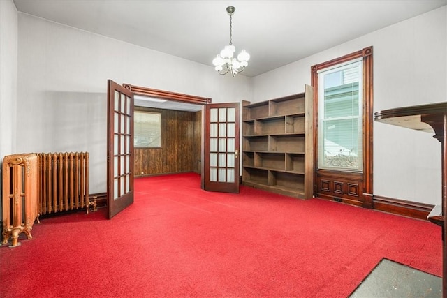 misc room with carpet, a chandelier, radiator, and french doors