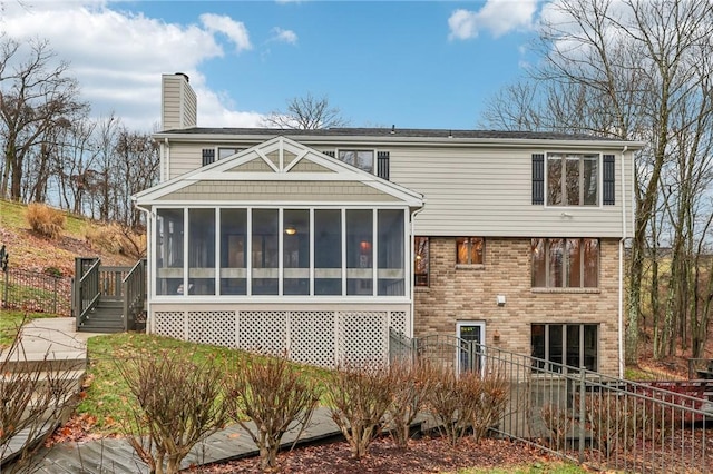 back of house featuring a sunroom