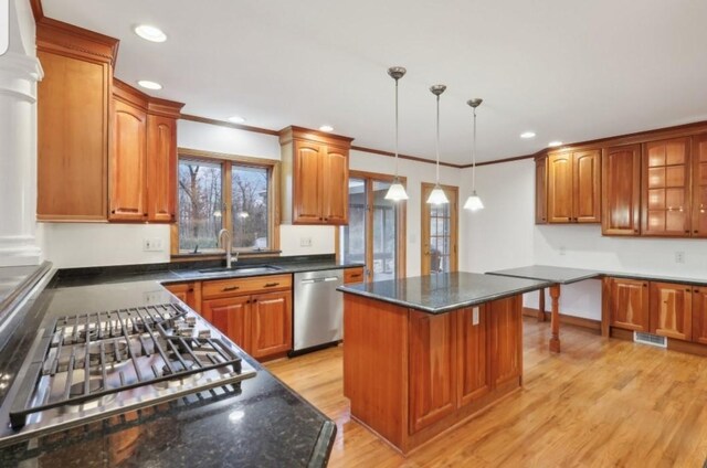 kitchen with dishwasher, sink, pendant lighting, light hardwood / wood-style floors, and a kitchen island