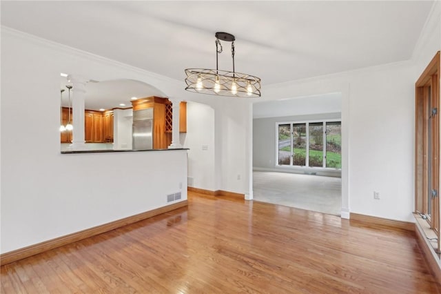 interior space with light hardwood / wood-style floors and ornamental molding