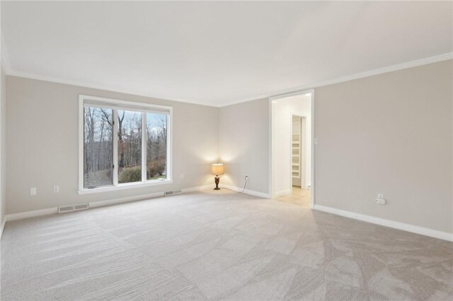 empty room with light carpet and ornamental molding