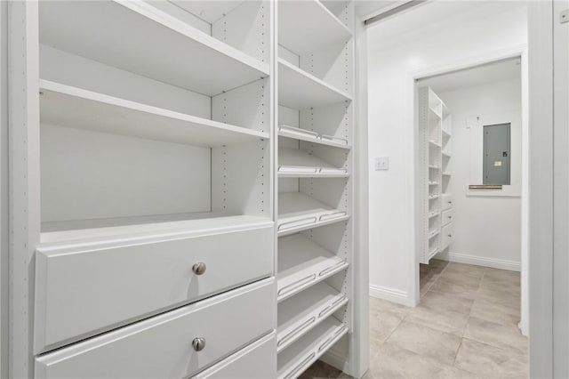 walk in closet with light tile patterned floors and electric panel