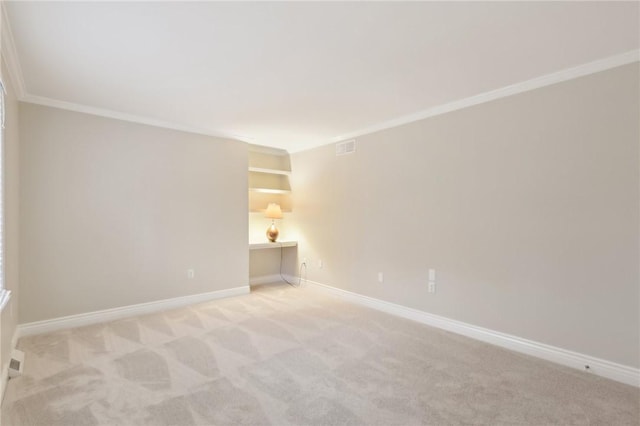 carpeted spare room featuring built in features and ornamental molding