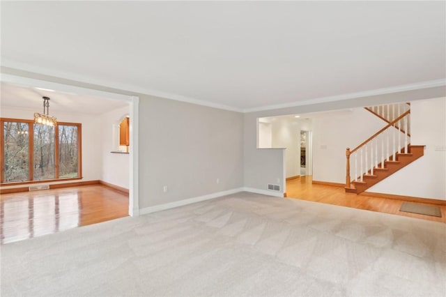 interior space with hardwood / wood-style floors, a chandelier, and ornamental molding