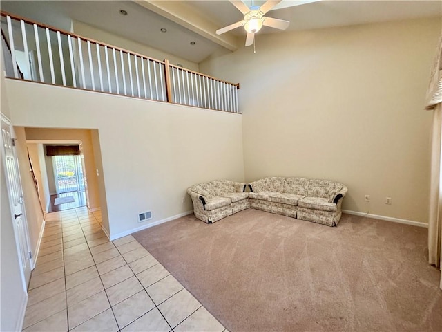 unfurnished room featuring beam ceiling, light colored carpet, high vaulted ceiling, and ceiling fan