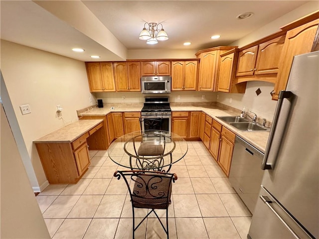 kitchen featuring light tile patterned flooring, appliances with stainless steel finishes, an inviting chandelier, and sink