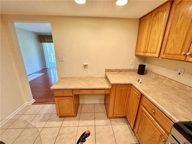 kitchen with backsplash, light tile patterned flooring, and range