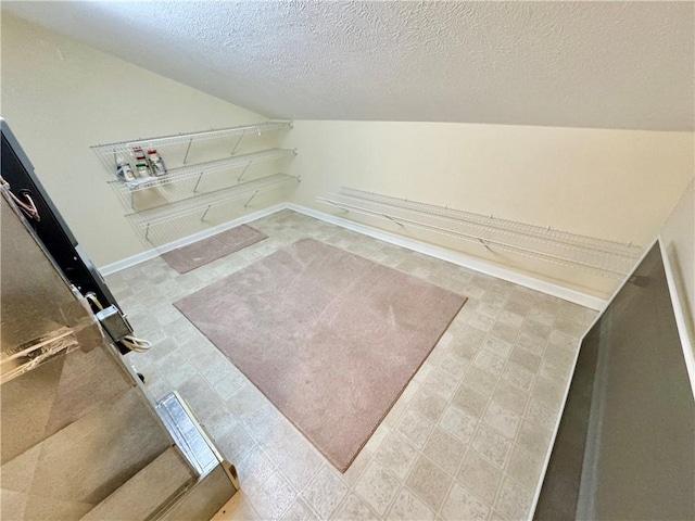 interior space featuring hookup for a washing machine and a textured ceiling