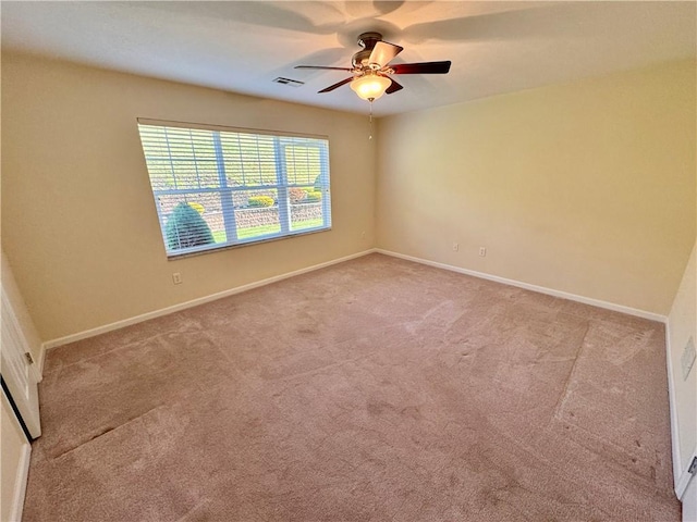 spare room featuring ceiling fan and light colored carpet