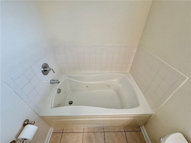 bathroom with tile patterned flooring and tiled bath