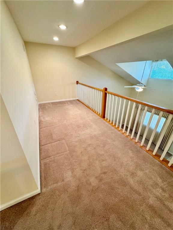 bonus room featuring beamed ceiling, carpet floors, and a skylight